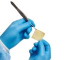 Surgeon holding square XenoSure Patch