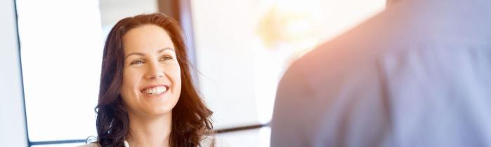 Happy woman sitting across from someone