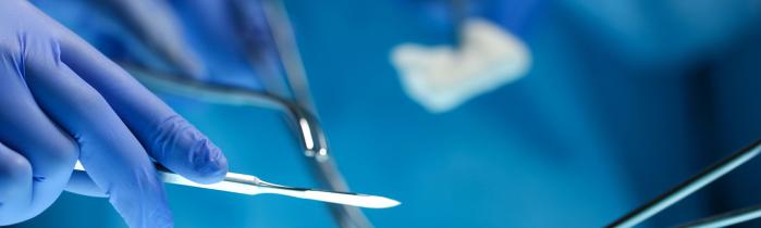Hands holding surgical instruments